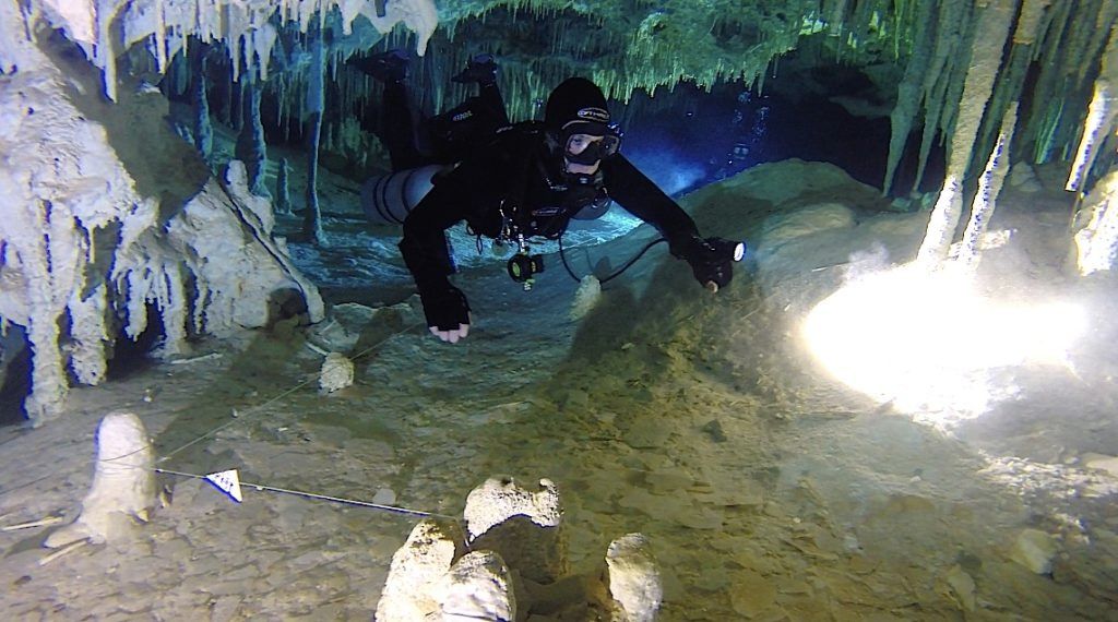 Technical diver running a line through an overhead cave
