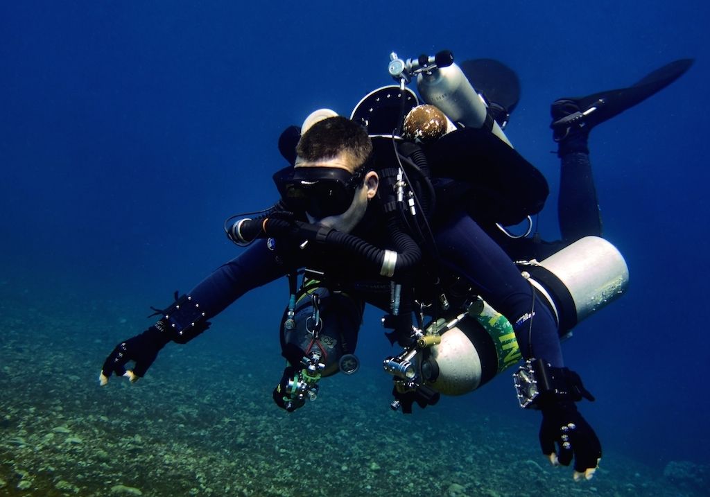 Rebreather diver carrying stage and bailout cylinders