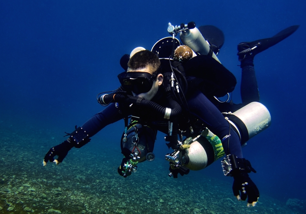 Rebreather diver carrying stage and bailout cylinders